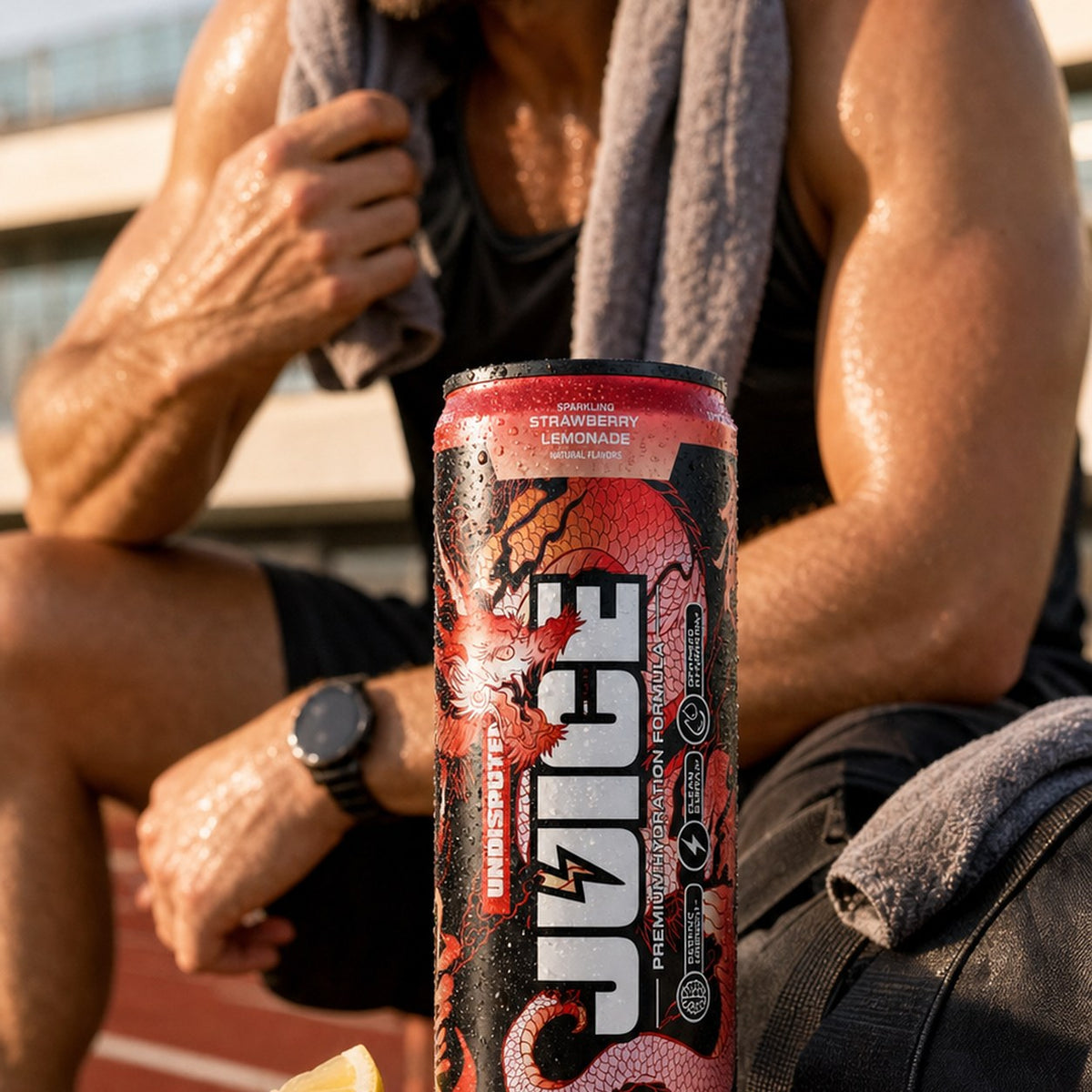 JUICE Sparkling Electrolytes: Strawberry Lemonade 24 pack lifestyle shot in a gym setting